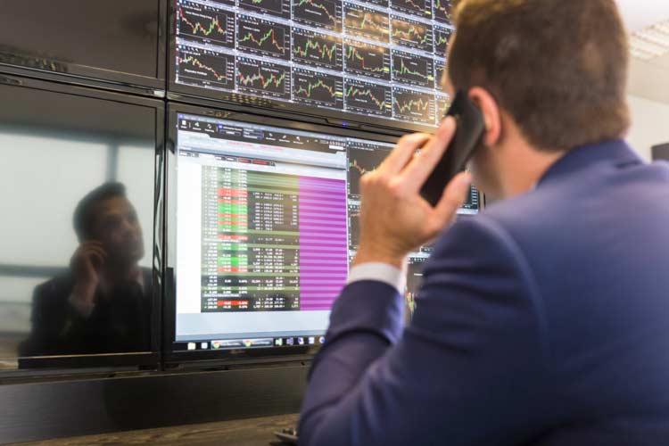 Options Trader Reviewing Charts and Open Positions